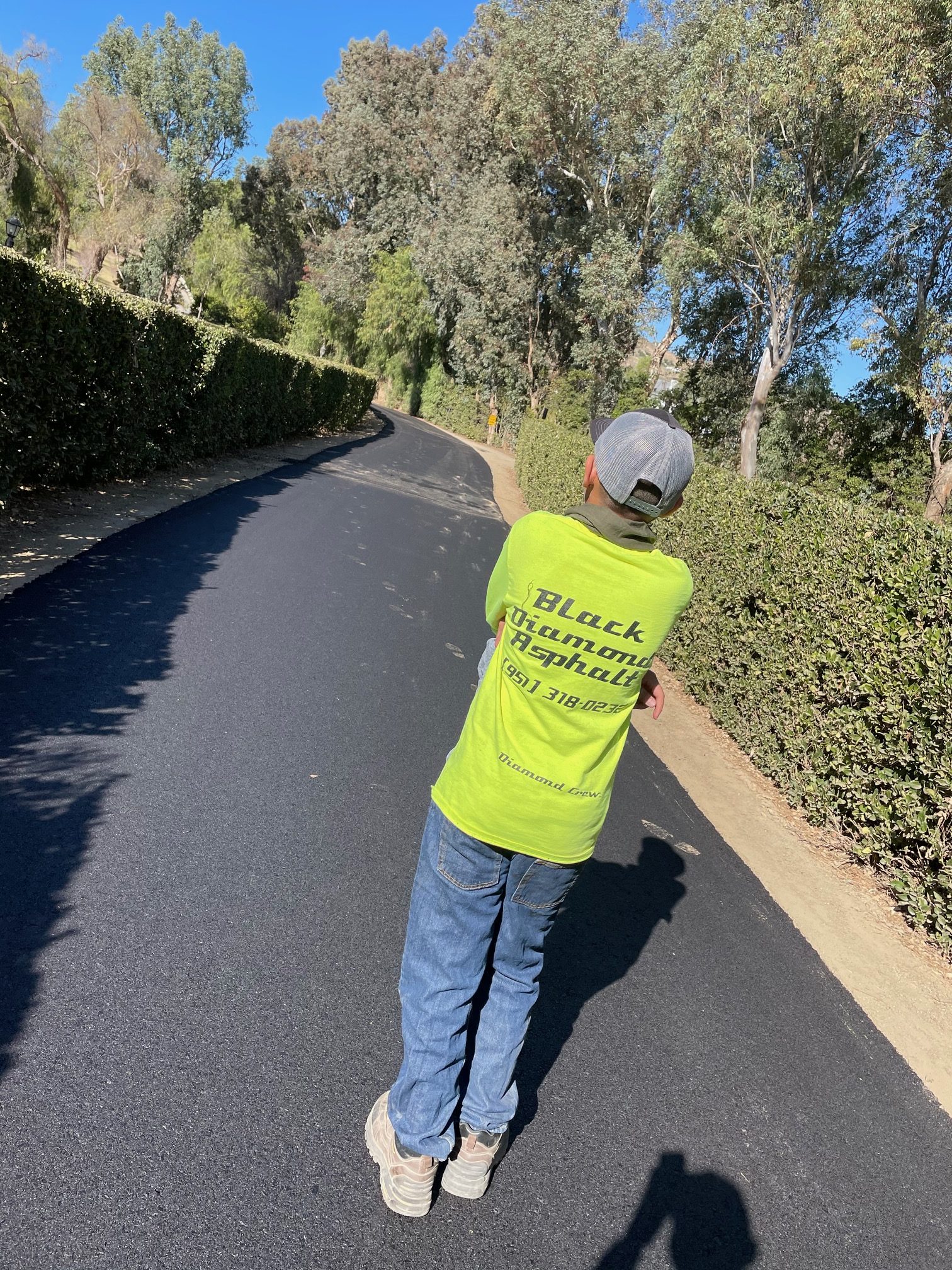 a guy in green t-shirt standing on a road